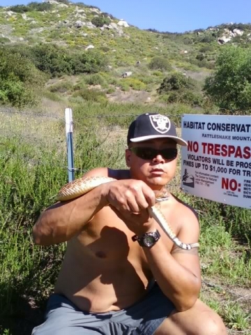 Holding a rattlesnake that I caught and returning it to a rattlesnake habitat